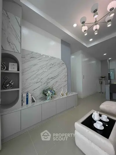 Modern living room with elegant marble accents and stylish lighting