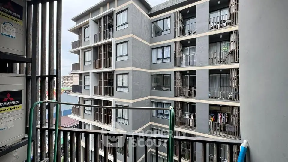 Modern apartment building exterior with balconies and urban view