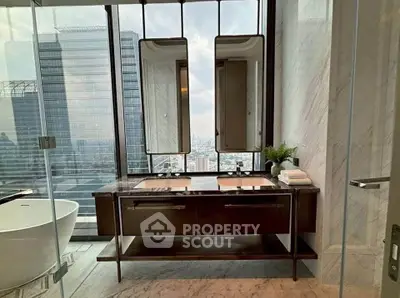 Luxurious bathroom with city view, featuring modern double vanity and freestanding bathtub.