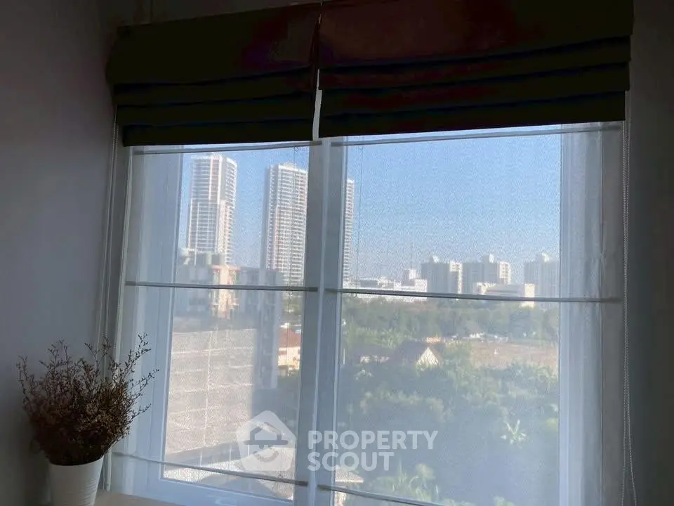 Stunning urban view from modern apartment window with city skyline