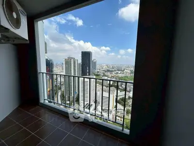 Stunning high-rise balcony view overlooking city skyline with clear blue skies.