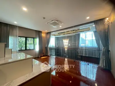 Luxurious living room with elegant chandelier and large windows