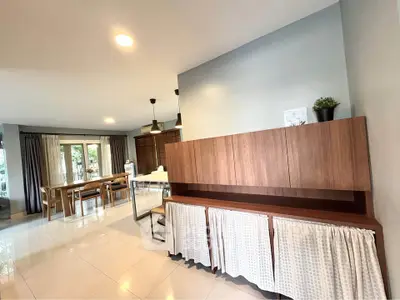 Spacious open-plan living and dining area with modern furnishings and natural light.