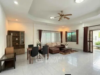 Spacious living room with modern furniture and large windows for natural light