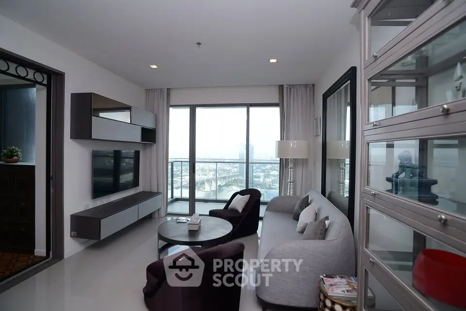 Modern living room with sleek furniture and panoramic city view.