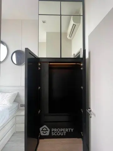Modern bedroom with open black wardrobe and stylish decor