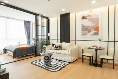 Modern open-plan living room with stylish decor and cozy bedroom area