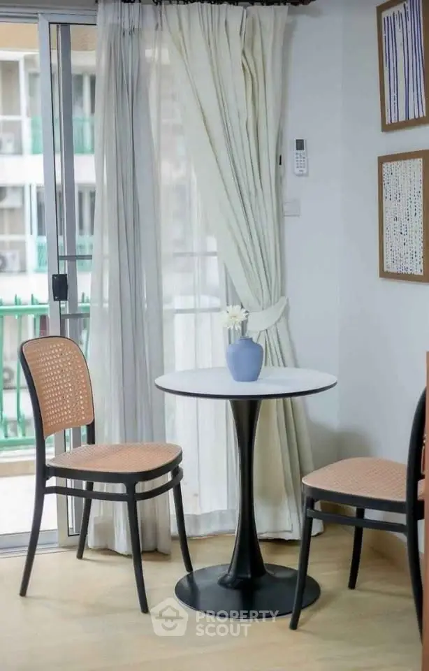 Charming corner with elegant table and chairs near balcony in modern apartment