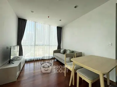 Modern living room with floor-to-ceiling windows and stylish furniture