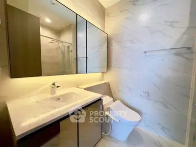 Modern bathroom with sleek fixtures and marble tiles