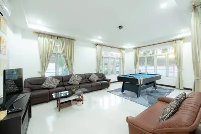 Spacious living room with pool table and elegant decor