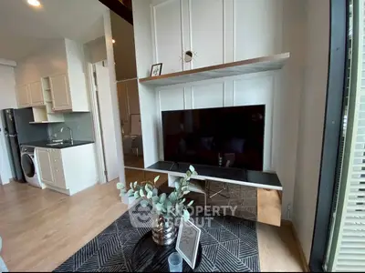 Modern living room with sleek TV setup and open kitchen layout