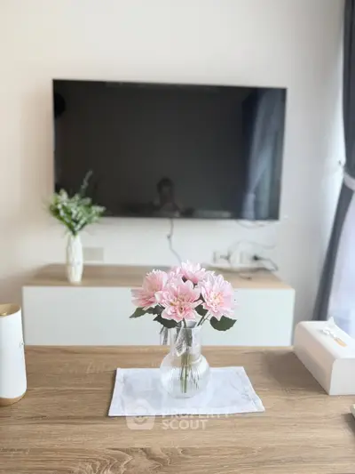 Modern living room with wall-mounted TV and elegant floral decor