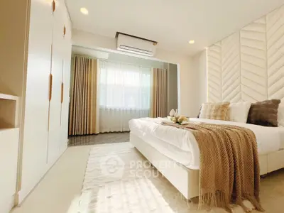 Luxurious modern bedroom with elegant decor and ample natural light