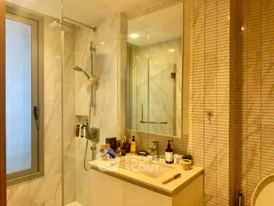 Modern bathroom with sleek shower and elegant marble tiles