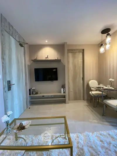 Modern living room with elegant decor and dining area, featuring stylish lighting and cozy ambiance.