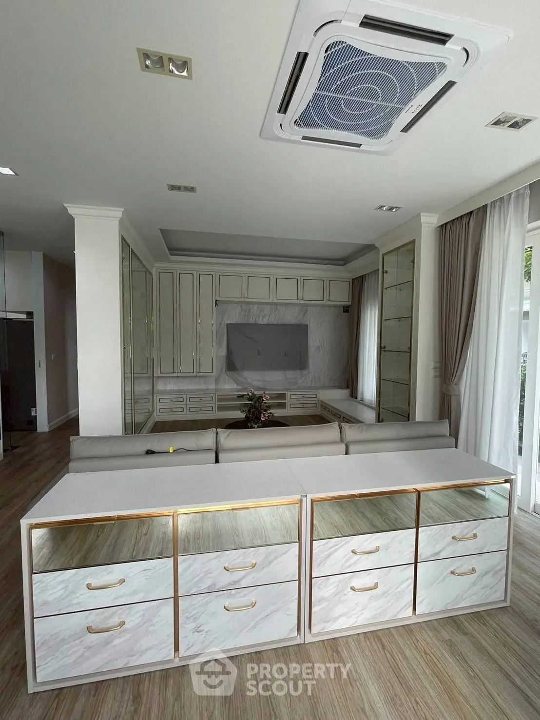Spacious living room with modern built-in storage and elegant ceiling design