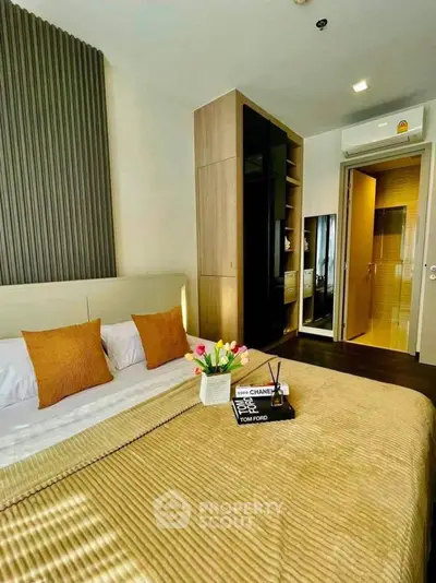 Luxurious bedroom with modern decor and ensuite bathroom, featuring elegant bedding and stylish storage solutions.