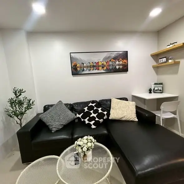 Stylish living room with black leather sofa and modern decor