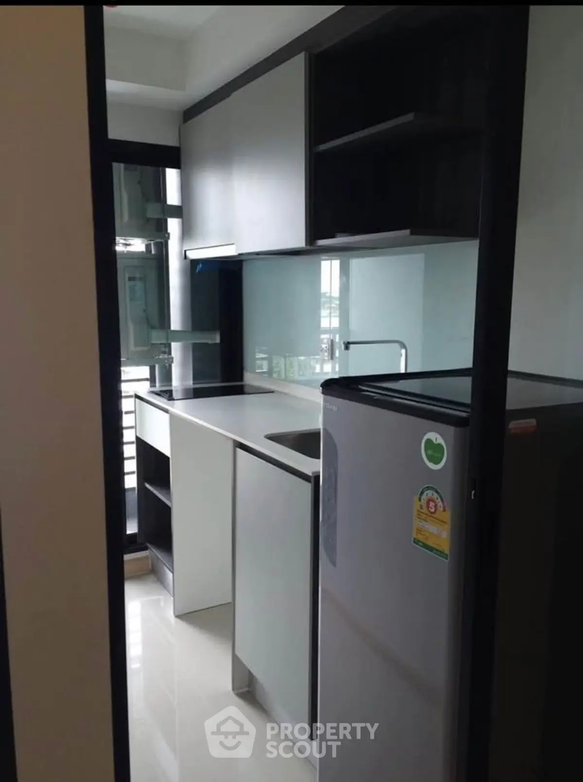 Modern compact kitchen with sleek cabinetry and stainless steel appliances