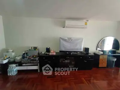 Spacious living room with parquet flooring and modern entertainment setup