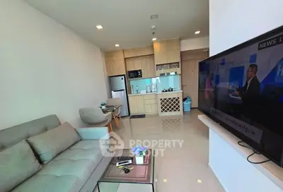 Modern living room with open kitchen layout and stylish furniture