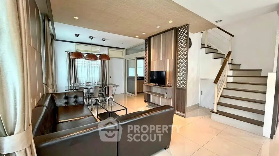 Modern living room with elegant decor and staircase in a stylish home