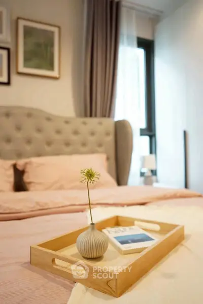 Cozy bedroom with elegant decor and soft lighting, featuring a stylish bed and decorative tray.