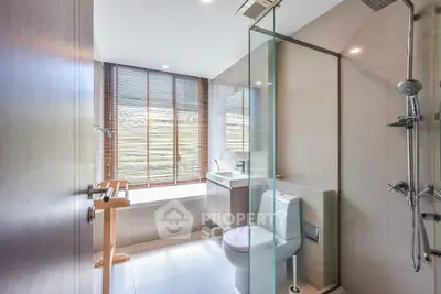 Modern bathroom with glass shower and natural light