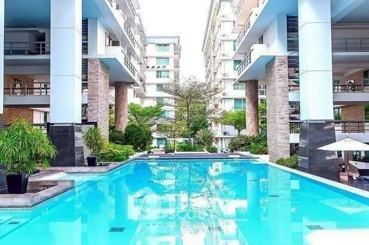 Luxurious apartment complex with stunning pool and modern architecture, perfect for upscale urban living.