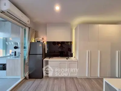 Modern living room with sleek design and integrated kitchen appliances