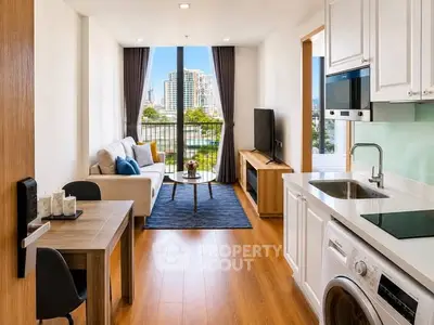 Modern open-plan living room with kitchen, featuring city view and stylish furnishings.