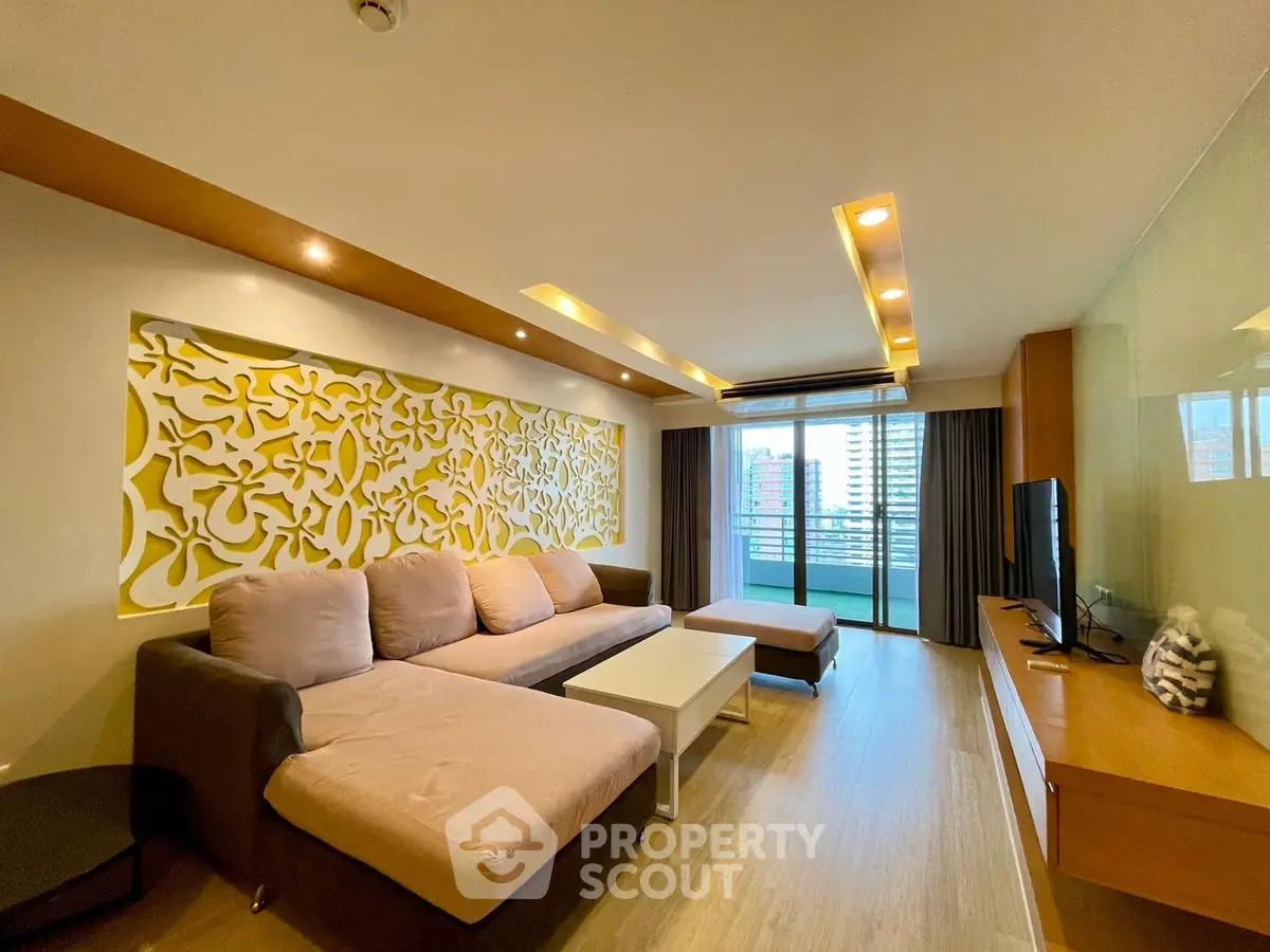 Spacious modern living room with stylish decor and city view balcony.