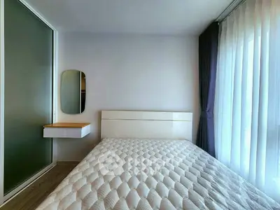 Modern bedroom with minimalist design and large window for natural light.