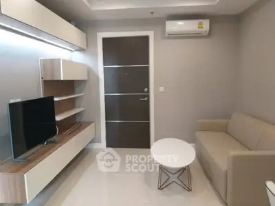 Modern living room with sleek furniture and wall-mounted TV