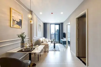 Modern living room with elegant decor and city view balcony, perfect for urban living.