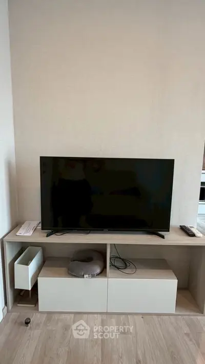 Modern living room with sleek TV setup and stylish wooden flooring