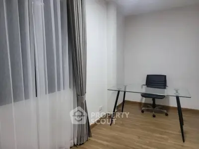Modern minimalist study room with glass desk and sleek chair