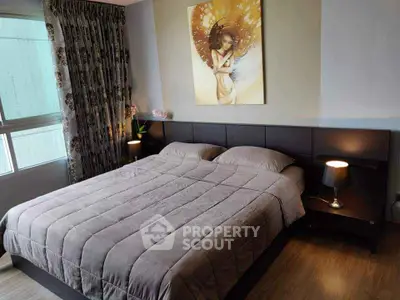 Cozy bedroom with modern decor and stylish artwork, perfect for relaxation.