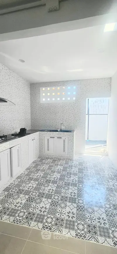 Modern kitchen with stylish patterned tiles and open layout design
