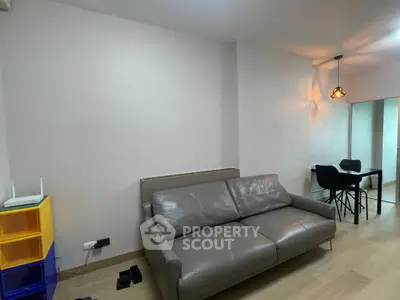 Modern living room with sleek leather sofa and stylish dining area