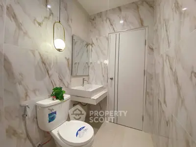Luxurious marble bathroom with modern fixtures and elegant lighting