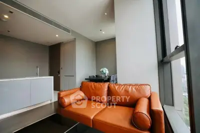 Modern living room with leather sofa and city view, featuring sleek design and natural light.