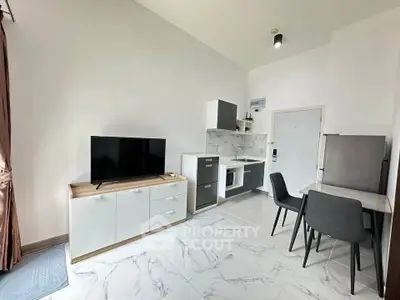 Modern studio apartment with sleek kitchen and cozy dining area