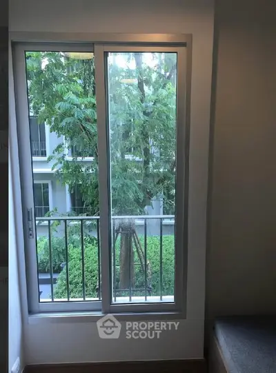 Bright window view with lush greenery from modern apartment