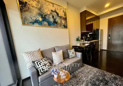 Modern living room with stylish decor and open kitchen layout in a cozy apartment.