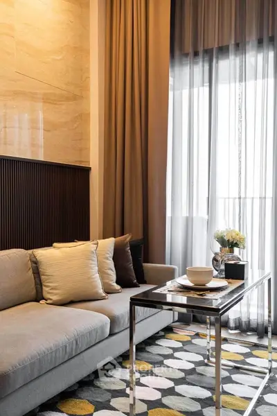 Stylish living room with modern decor and floor-to-ceiling windows