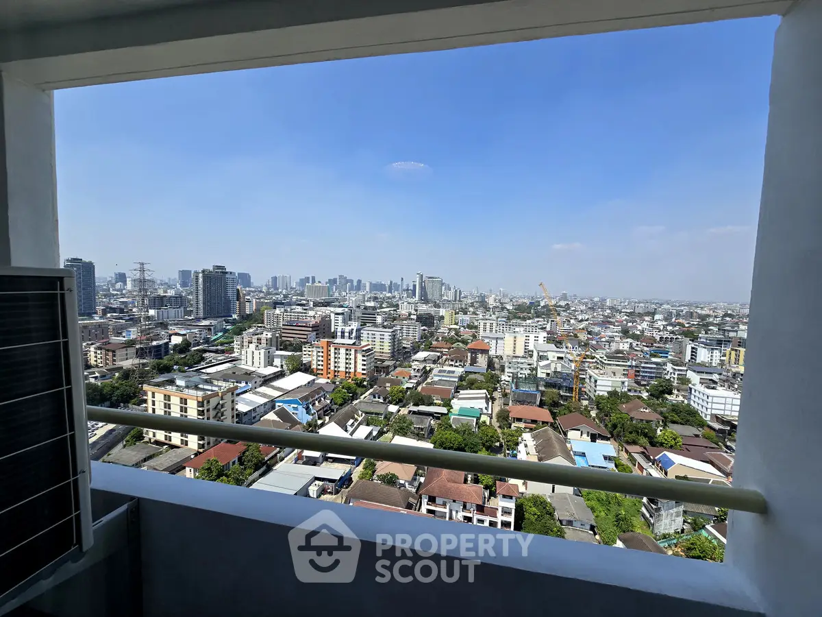 Stunning cityscape view from high-rise balcony overlooking urban skyline.