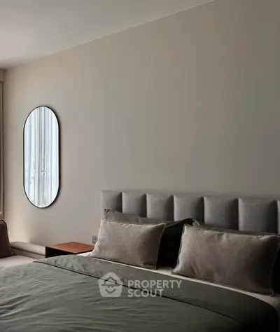 Elegant bedroom with modern decor and plush bedding in a stylish apartment.