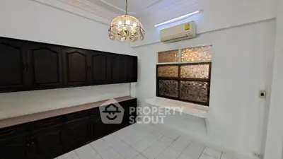 Spacious room with elegant chandelier and built-in cabinets